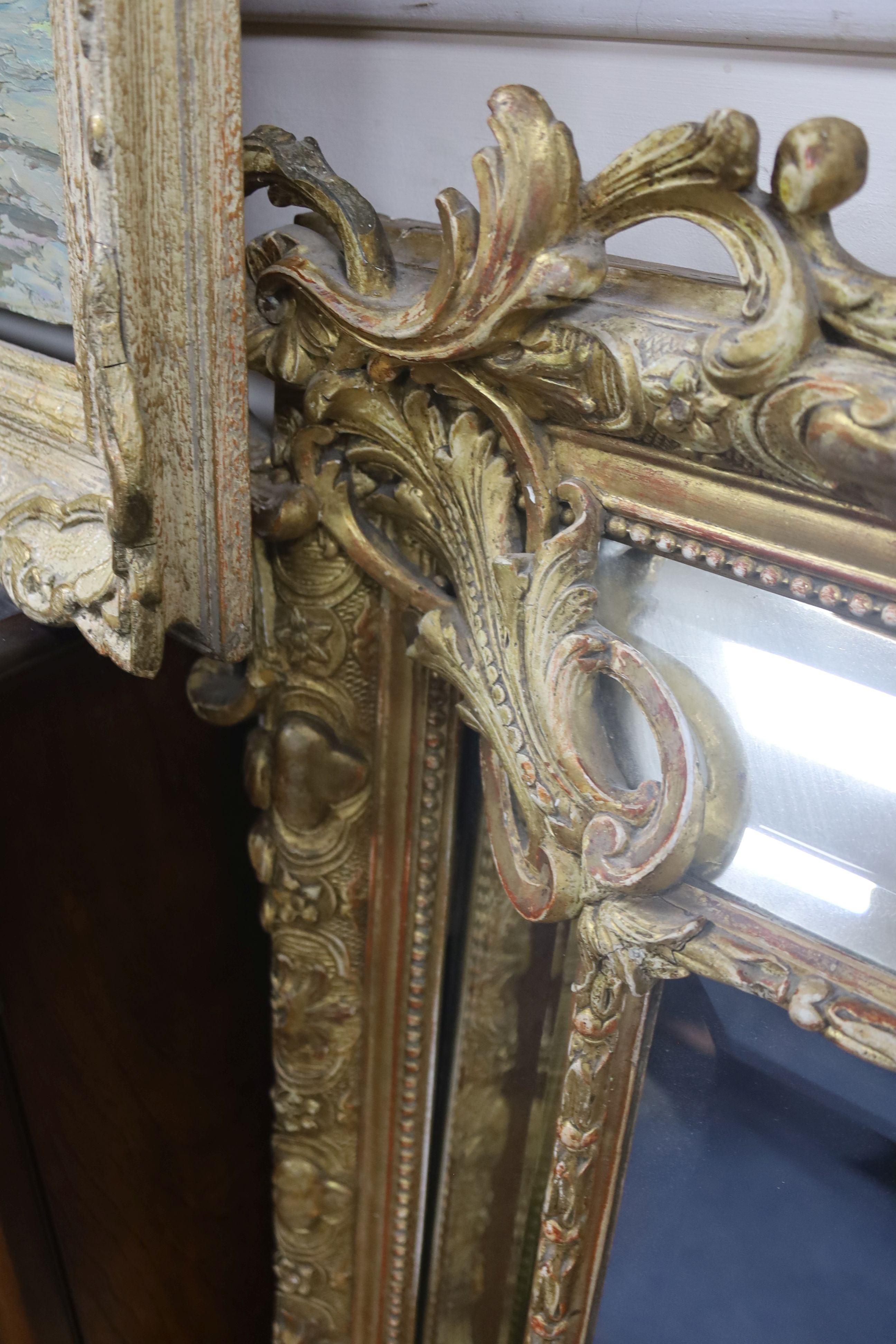 A large 19th century French gilt and gesso frame, bevel edged mirror with cushion margin, plated and C scroll, width 108cm, height 137cm